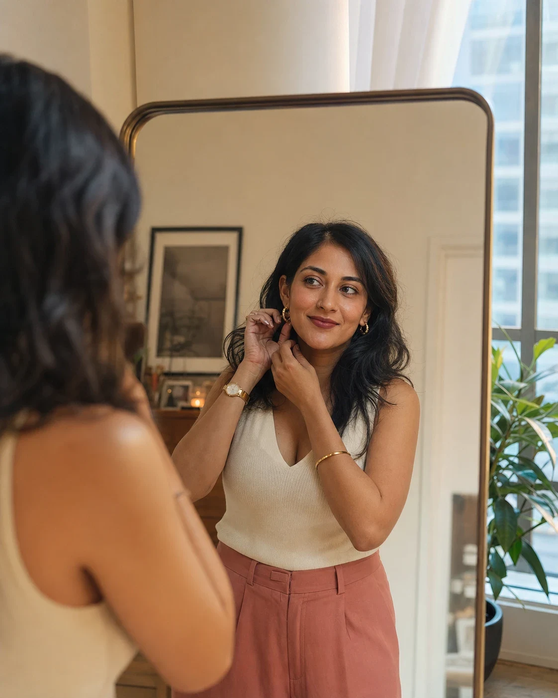 An adult smiling at their reflection while getting ready