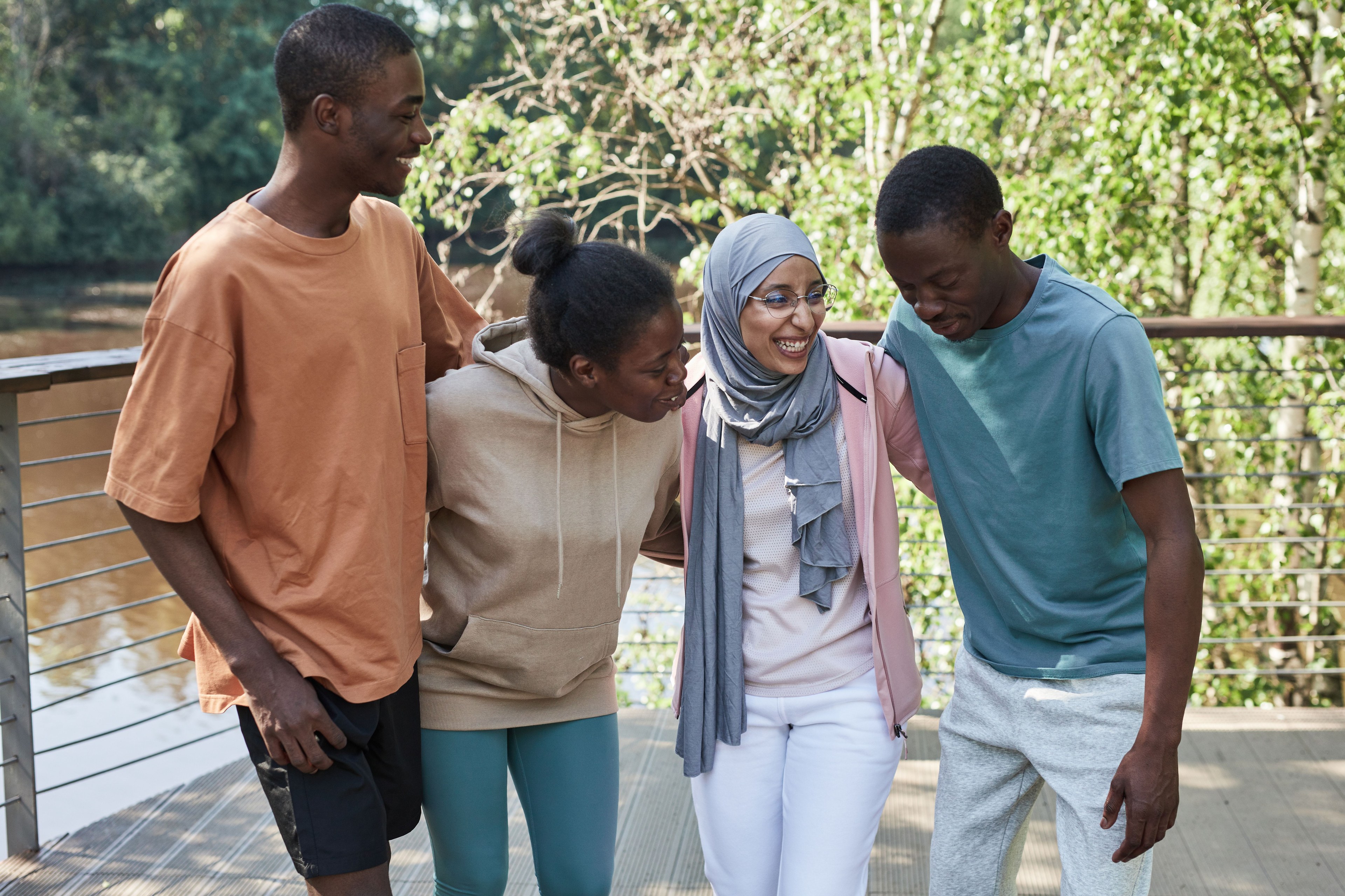 Four adult friends walking together outdoors